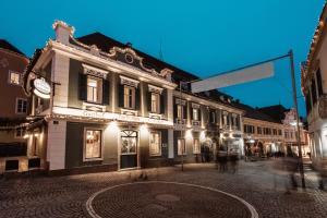 a group of buildings on a street at night at Altstadtappartements Hartberg in Hartberg