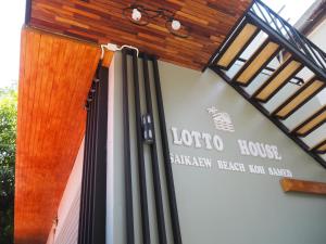a sign for a louko house with a wooden roof at Lotto House in Ko Samed