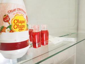 a counter with two bottles of sauce and a bag of ketchup at Lotto House in Ko Samed