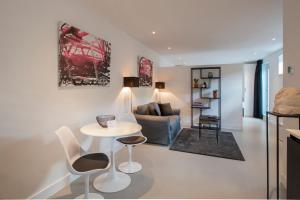 a living room with a table and chairs and a couch at Longhouse Studio Zandvoort in Zandvoort