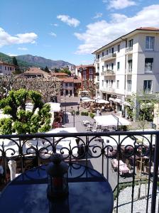 a view of a town from a balcony with a table at Nel cuore di Stresa in Stresa