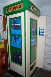 a green and white donation machine in a store at Tatler Jack in Killarney