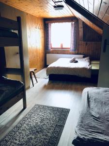 a bedroom with two beds and a window at Chata u Kostela in Dolni Misecky