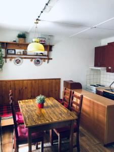 a dining room with a table and a kitchen at Chata u Kostela in Dolni Misecky