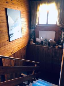 a staircase in a wooden house with a window at Chata u Kostela in Dolni Misecky