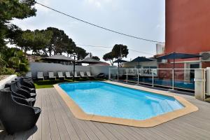 a swimming pool on the deck of a house at Hotel La Tuiliere in Carry-le-Rouet