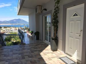 a door to a balcony with a view of the water at Chalkida Beautiful Home with Stunning Views in Chalkida