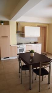 a kitchen with a table and chairs in a room at Residence Demetra in Gela