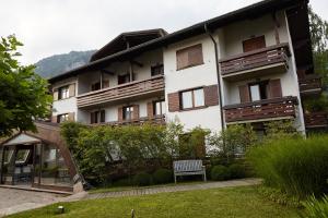 a building with a bench in front of it at Active Hotel in Castione della Presolana