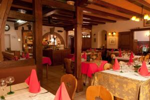 a restaurant with tables and chairs with pink napkins on them at La Griffe à Foin au Restaurant raisin D'or in Mittelbergheim