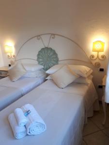 Łóżko lub łóżka w pokoju w obiekcie Hotel Sorgente