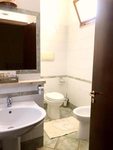 a bathroom with a sink and a toilet at Da Carmelo, Apartments & Rooms in Palinuro