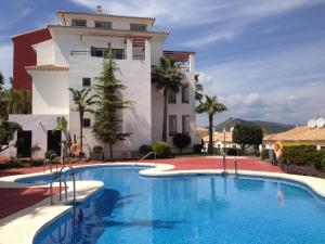 a large swimming pool in front of a building at Casa Mariposa in Alhaurín el Grande