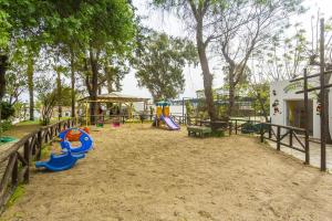 a playground with a slide and a play structure at Club Muskebi in Bodrum City