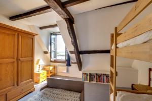 a small attic bedroom with a bunk bed and wooden beams at Le Corsaire de Solidor in Saint Malo
