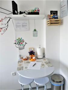 a white table with two stools in a room at Ruby room in Zagreb