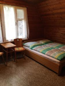 מיטה או מיטות בחדר ב-Chata Pod Bílým kamenem