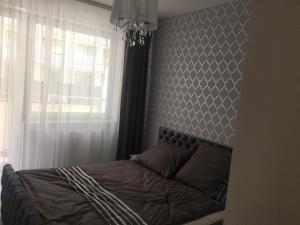 Posteľ alebo postele v izbe v ubytovaní AMD Apartamenty Bliżej Morza