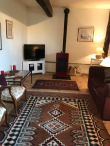 a living room with a couch and a fireplace at Gite du Paradis in Vieuzos