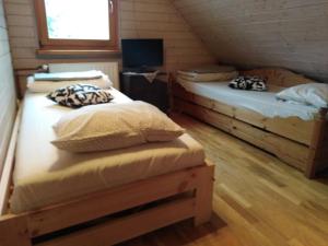A bed or beds in a room at Chata pod Bacówką