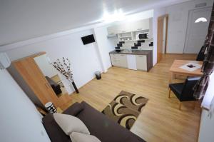 a living room with a couch and a kitchen at Guest House Korita in Grabovac