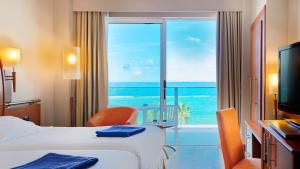 a hotel room with two beds and a view of the ocean at Bull Reina Isabel & SPA in Las Palmas de Gran Canaria