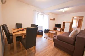 a living room with a table and a couch at Guest House Korita in Grabovac