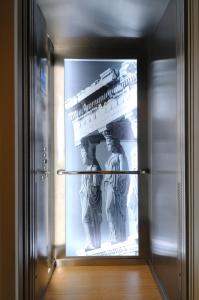 a statue in a glass door of a museum at Hotel Leto Hydra in Hydra