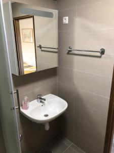 a bathroom with a sink and a mirror at Villa Repić in Slatina +35 photos