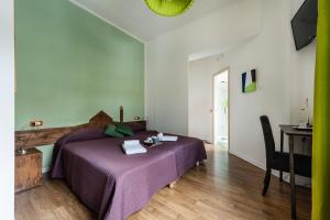 a bedroom with a bed and a desk at La Gemma Di Elena in Lucca