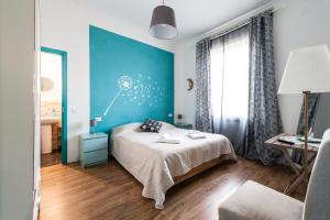 a bedroom with a large bed and a large window at La Gemma Di Elena in Lucca