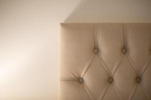 a beige couch against a white wall at Palazzo D'Ambra Residenza d'Epoca in Florence