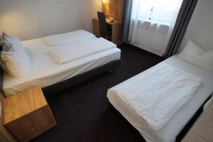 Postel nebo postele na pokoji v ubytování Hotel Fischertor