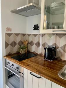 a kitchen with white cabinets and a counter top at Sandra's Lounge in Klagenfurt