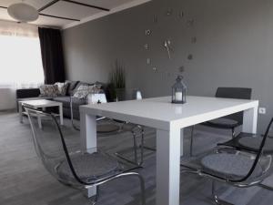 a white table and chairs in a living room at Apartment 144 in Kněževes