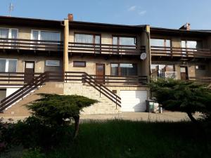 an apartment building with a staircase in front of it at Luxury Living Apartment in Kněževes