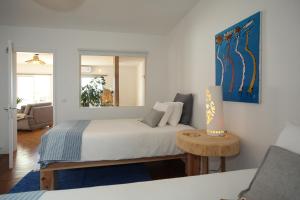 a bedroom with a bed with a table and a mirror at Villa Terra in Lagoa