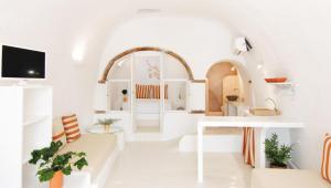 a living room with white walls and a white table at White Grape Suites in Oia