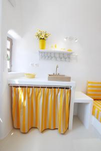 a kitchen with an orange and white sink and a counter at White Grape Suites in Oia
