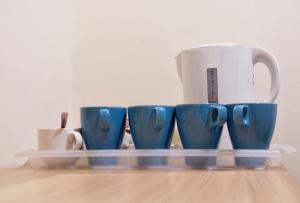 a group of blue cups sitting on a table at Little Foxes Hotel & Gatwick Airport Parking in Crawley