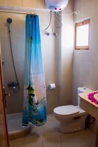 a bathroom with a shower curtain with a fish on it at El Primo Hotel Dahab in Dahab