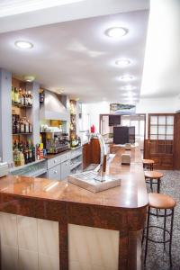 a large kitchen with a large wooden counter top at Eurohotel in Mahón