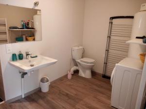 a bathroom with a white sink and a toilet at L'impératrice in Eaux-Bonnes