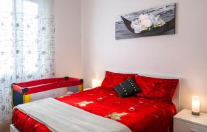 a bedroom with a red bed with a red comforter at Bright House in Milan in Milan