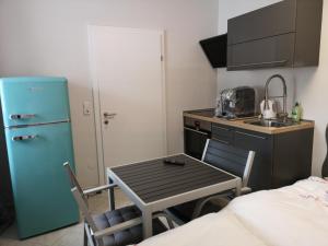 a small kitchen with a table and a sink at Ipfmühle Studio 1 (Hafer) in Hargelsberg