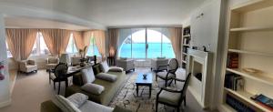 a living room filled with furniture and a large window at Hotel Miramare & Spa in Sestri Levante