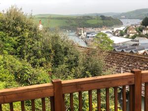 a view of a river from a wooden bench at Suncot Apartment in Salcombe