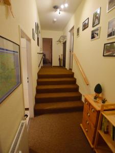 a hallway with stairs in a home with a stair case at Ferienwohnung HEXE mit Komfort **** in Sankt Andreasberg +9 photos