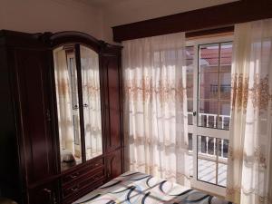 a bedroom with a dresser and a window at Blue Tex in Vila Chã