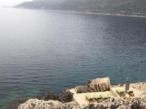 a group of chairs sitting on the edge of a body of water at Mandalina Suites in Kaş